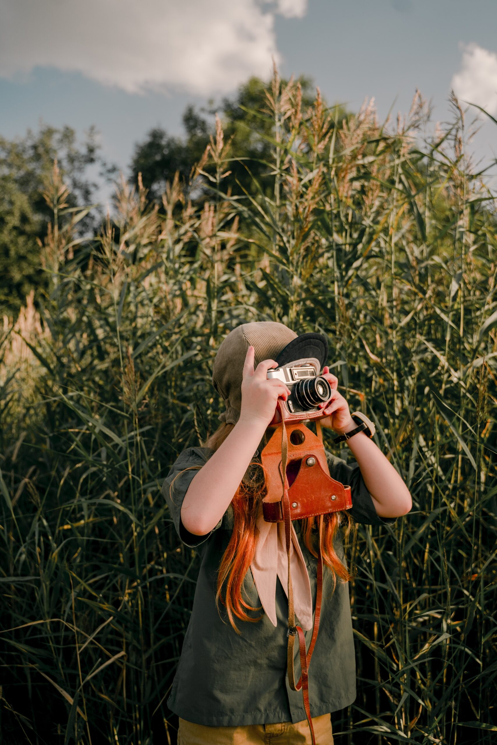 Girl Taking Picture Near Wheat Field