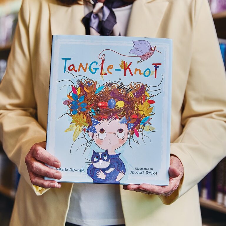 Loretta Ellsworth Holding a copy of Tangle-Knot.