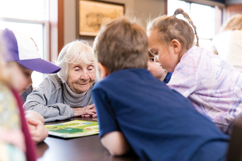 Children at All Seasons Preschool in Eagan play games with the seniors who live in housing connected to the school.