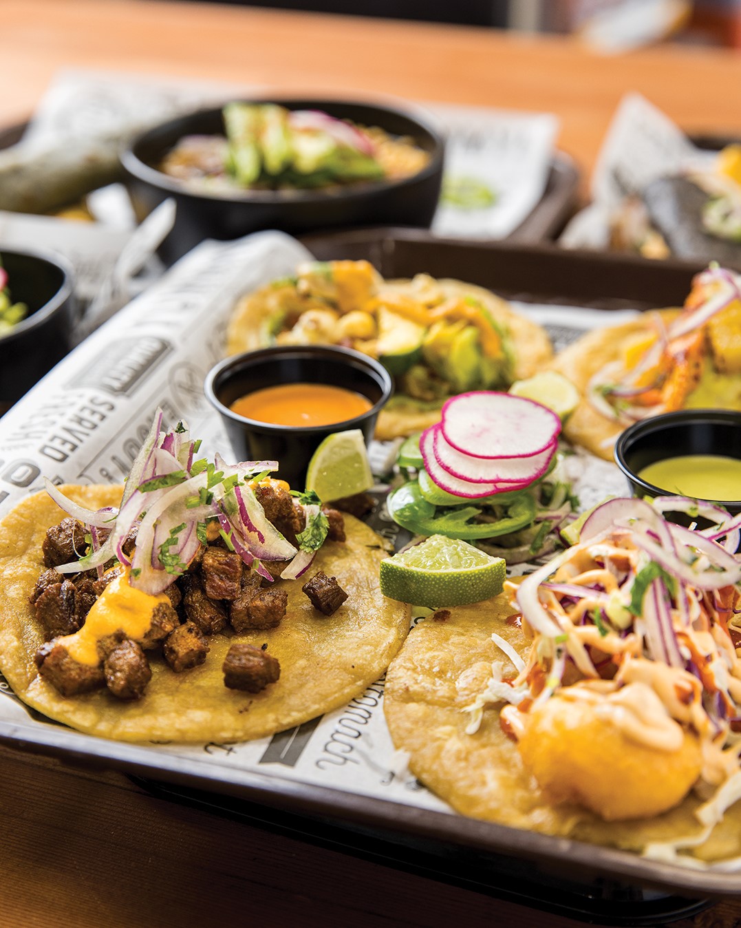 The menu offers a variety of tacos, including braised beef, chicken, grilled steak, shrimp, slow roasted pork and vegetable.
