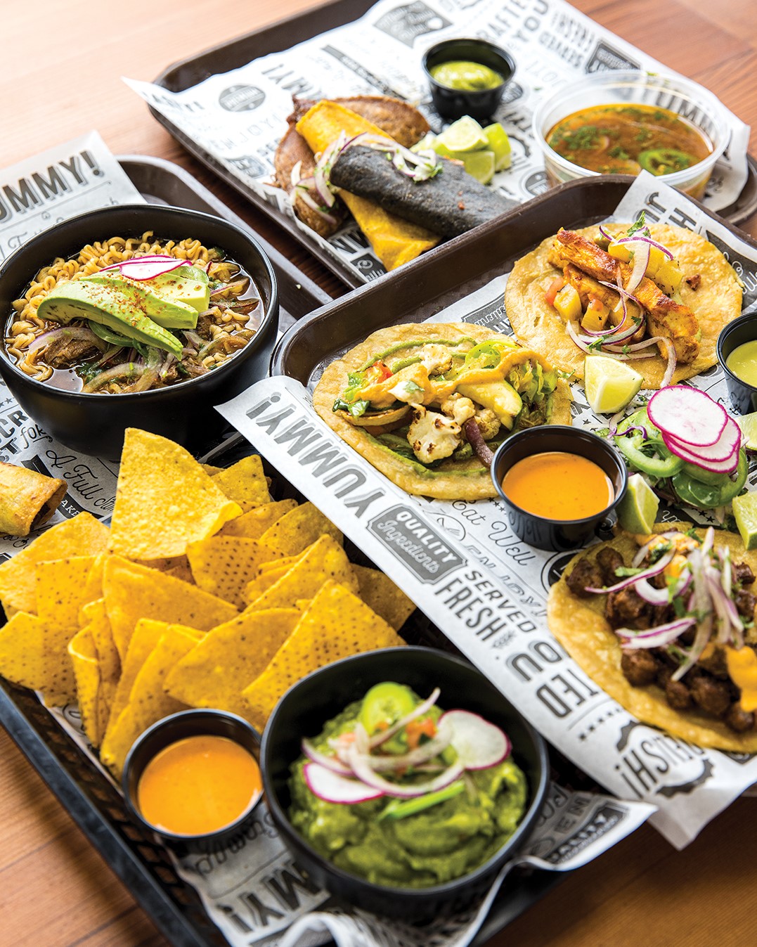 The Birria Ramen (top left) and Quesabirria (top right) are two popular menu items. Customers also enjoy tacos (bottom right) and guacamole with chips (bottom left).