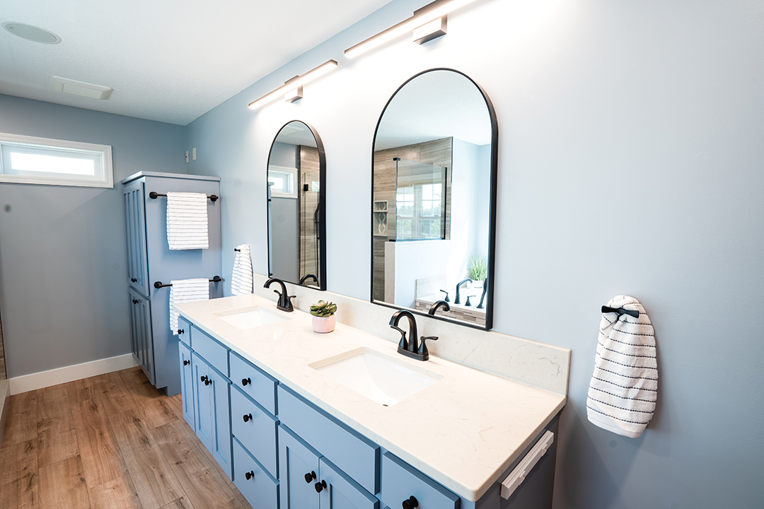 Kiger updated this bathroom by swapping outdated cabinet pulls for a modern design and changing the wall color to create the feeling of a bigger, brighter space.