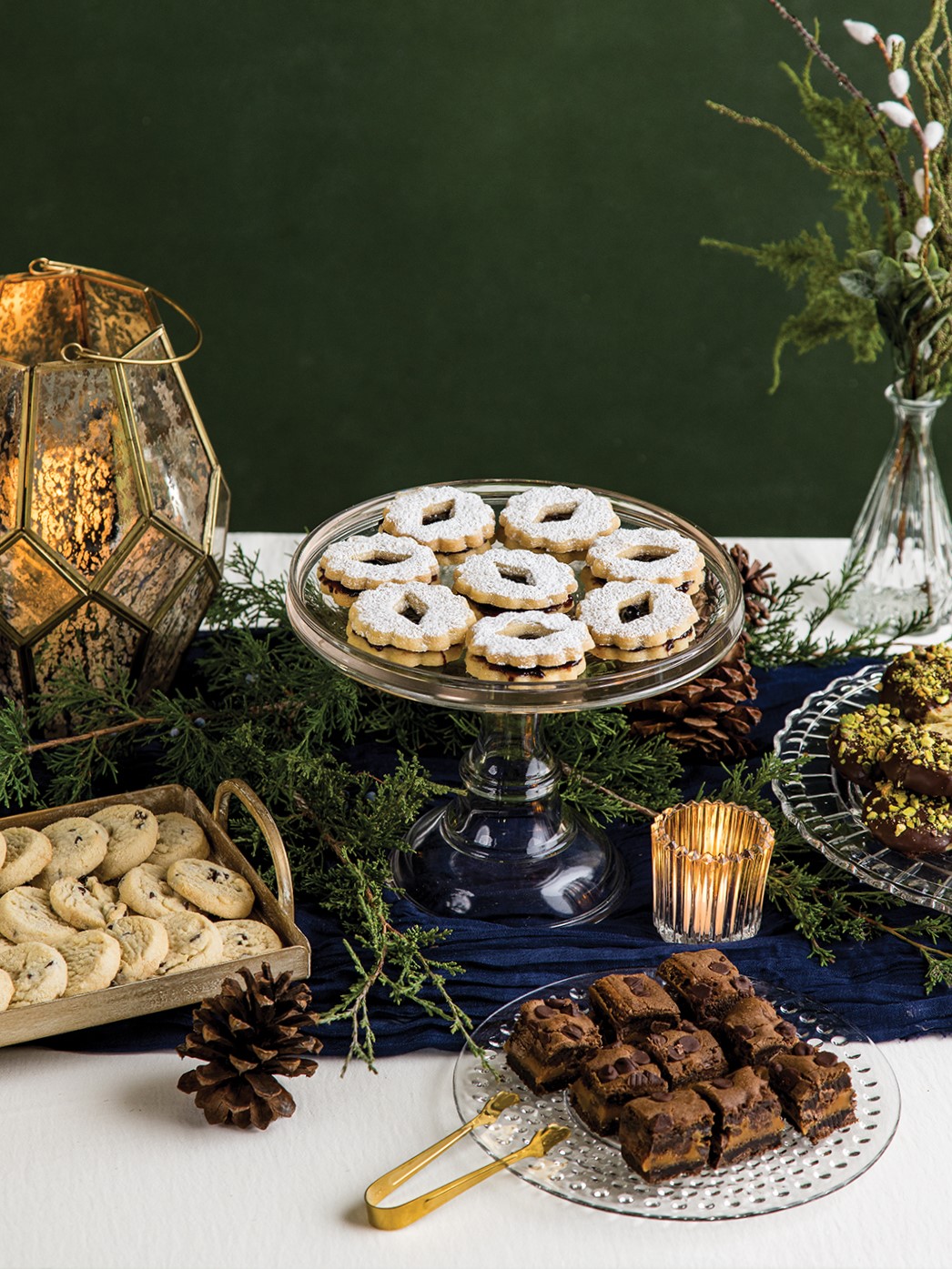 Elevate a potluck dessert buffet by creating a beautiful tablescape and setting up serving dishes for guests to fill with sweet offerings.