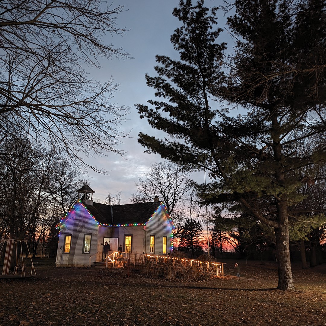 The school lit up for Christmas in the Village at Dakota City Heritage Village.