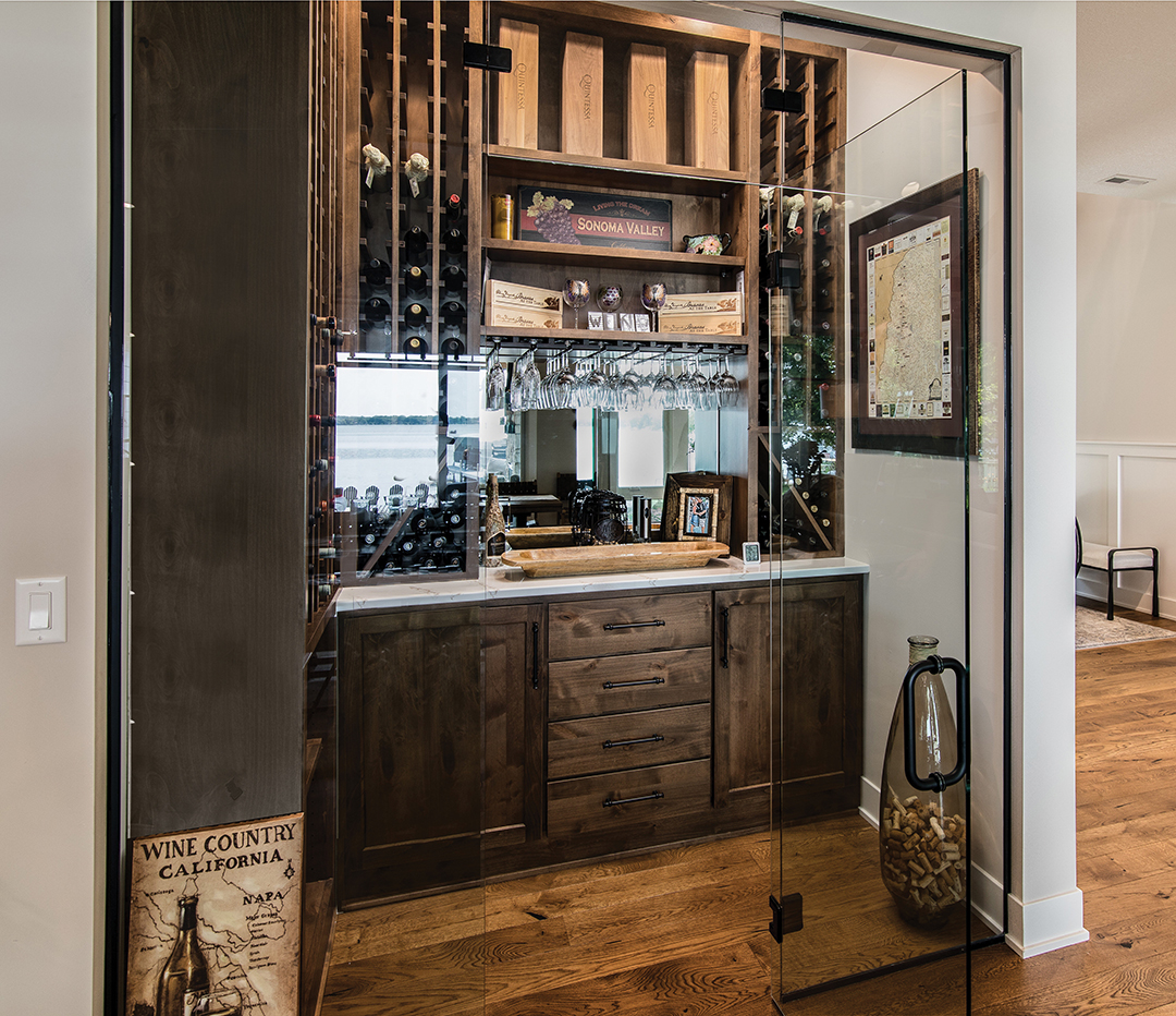 The wine cellar serves as a distinctive focal point on the home’s main floor and provides the perfect space to display the couple’s red wine collection and memorabilia.