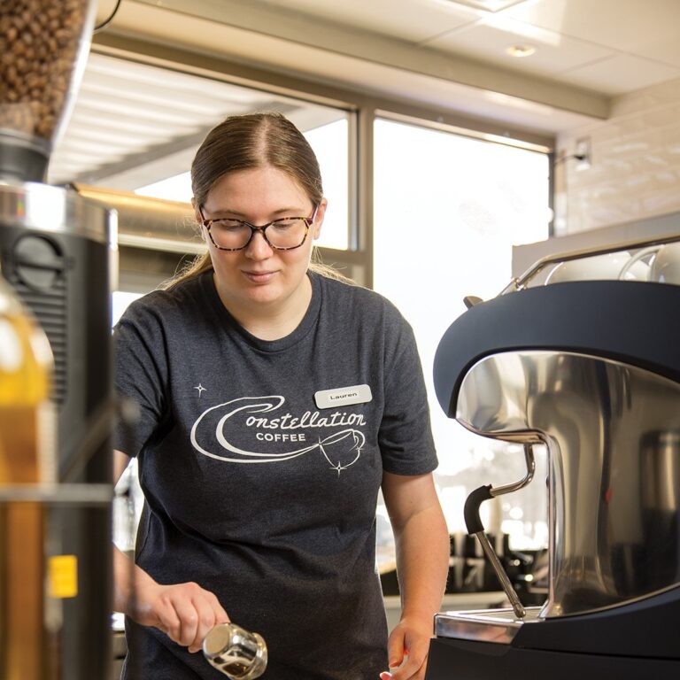 Lauren Ziehwein, who has worked at Constellation Coffee since it opened in July, makes a latte.