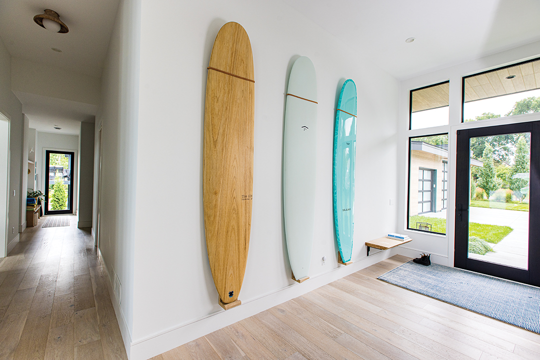 Three surfboards decorate the home’s entrance, contributing to the home’s West Coast modern flair.