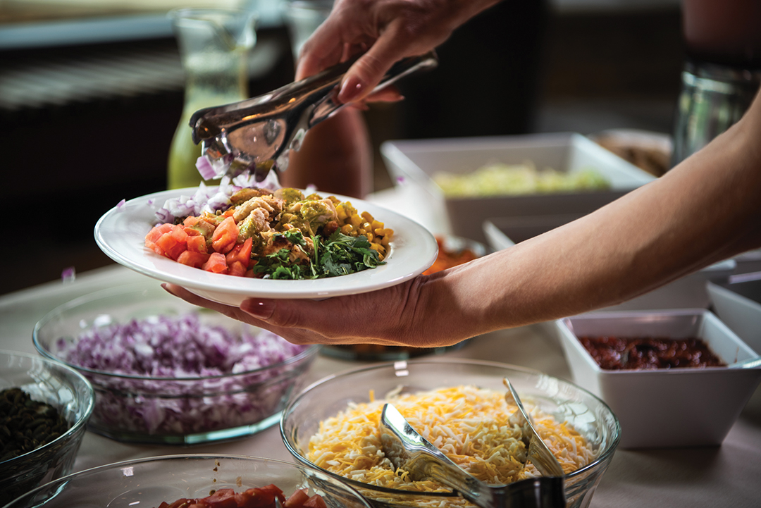 Guests assemble thier burrito bowl from the South of ’Sota menu.