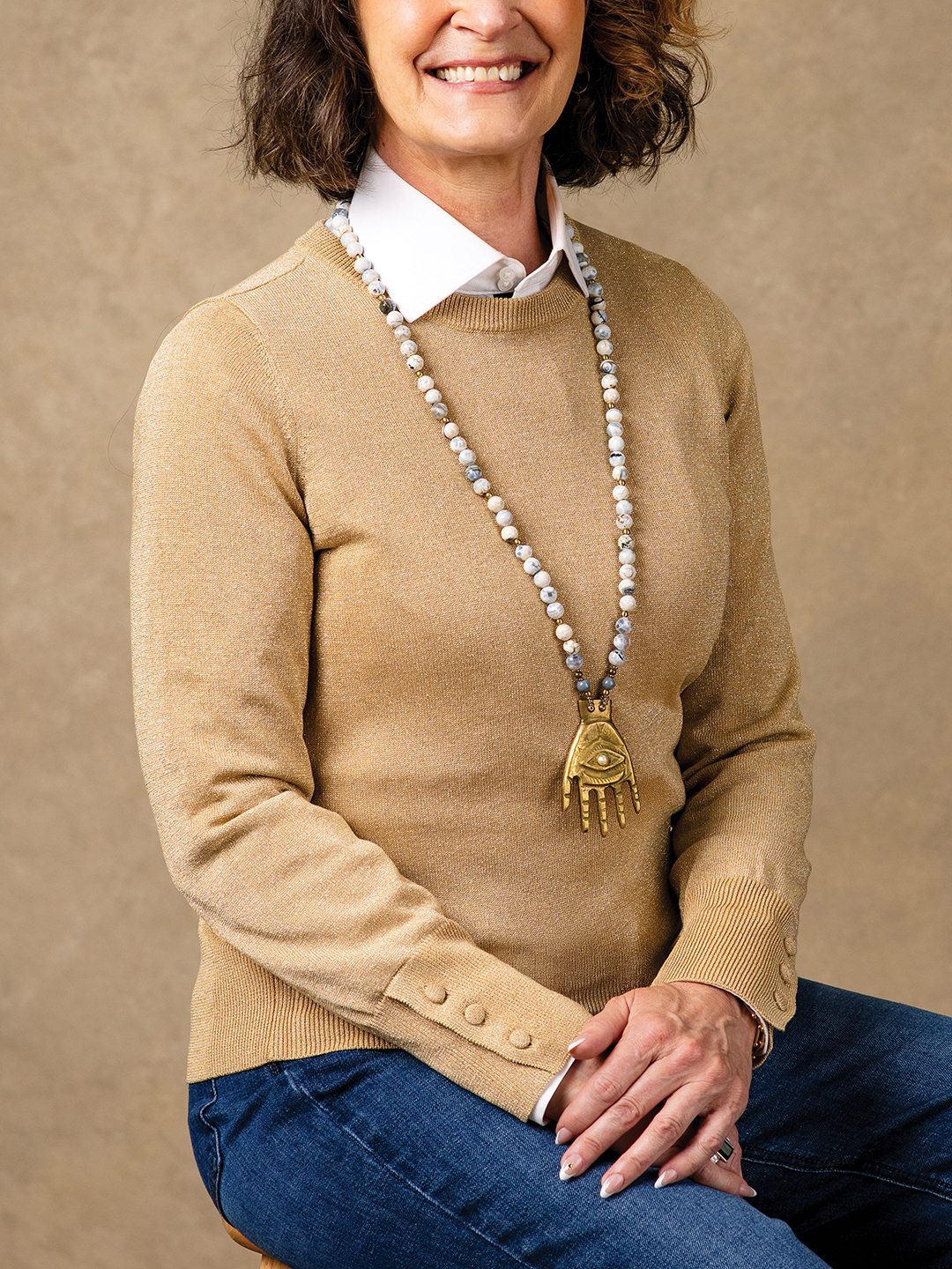 Weekend Style (left): Run a few errands without worrying about who sees you while you’re out and about. Denise McBride’s gold knit crewneck, which came without tags from a consignment store, is paired with a necklace from Fallon Art Advisory 
( @fallon.art.advisory) and Neems bespoke dark denim straight leg stretch high rise jeans ($229). The white button-down from J. Hilburn continues to prove its worth.