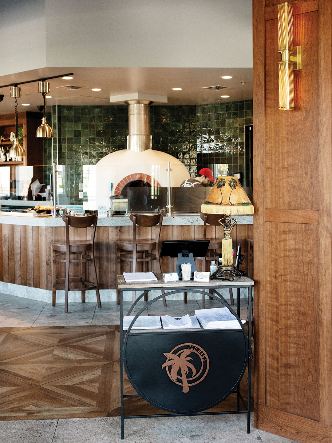 A hardworking pizza oven sits behind the bar at Pau Hana.